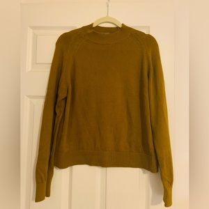 Everlane cotton mockneck sweater in rich golden color